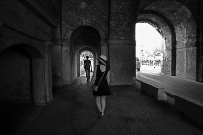 Young woman standing in corridor