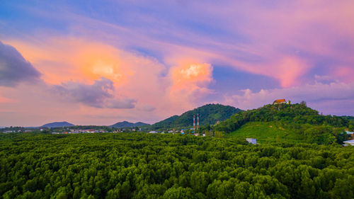 Scenic view of field against sky during sunset