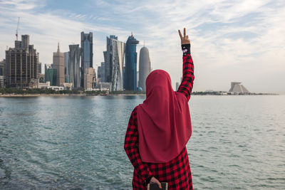 Rear view of woman against city of doha, qatar. 