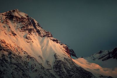 Scenic view of snow mountains against sky at dusk