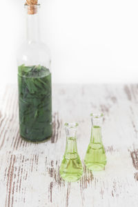 Close-up of glass bottle on table against white background