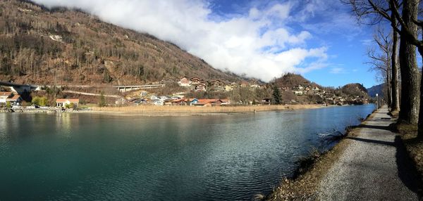 Panoramic view of buildings by mountains against sky