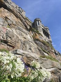 Low angle view of cliff against sky