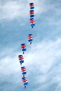 Low angle view of flag flying against sky