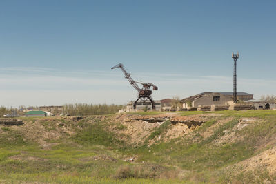 Traditional windmill on field against clear sky