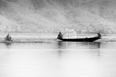 Man on boat in lake