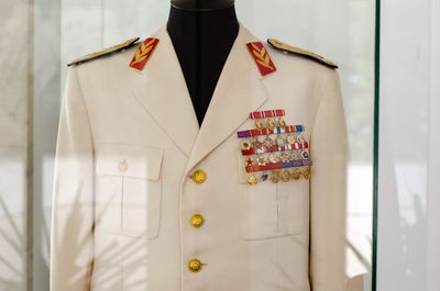 Close-up of clothes hanging on white wall