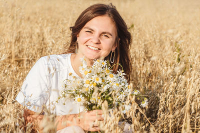 Portrait of a smiling young woman in field