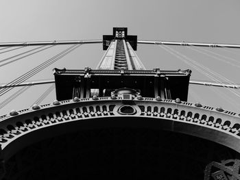 Low angle view of suspension bridge against clear sky