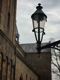 Low angle view of building against cloudy sky