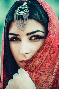 Portrait of beautiful young woman wearing scarf
