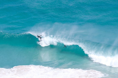 High angle view of surfers in sea