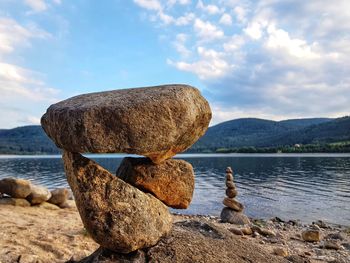 View of rocks in lake against sky