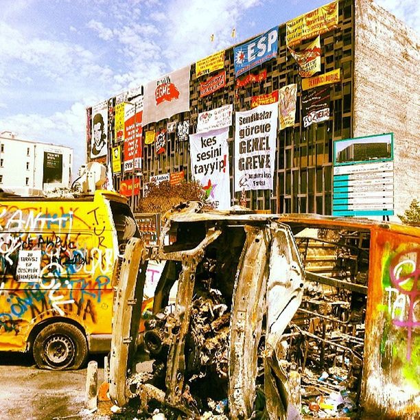 architecture, built structure, building exterior, graffiti, transportation, text, sky, land vehicle, mode of transport, bicycle, wall - building feature, day, western script, building, outdoors, city, stationary, residential building, residential structure, no people