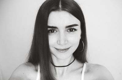 Portrait of smiling woman against wall at home