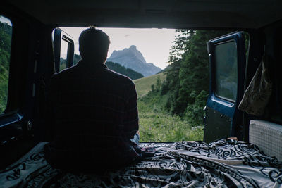 Rear view of man sitting in bus