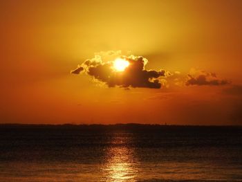 Scenic view of sea against orange sky