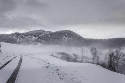 Scenic view of snow covered mountains against sky