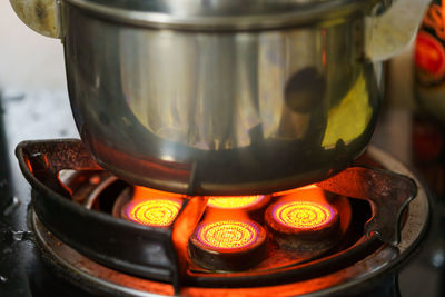 Close-up of tea cup on barbecue grill