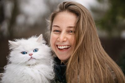 Portrait of smiling young woman with eyes closed