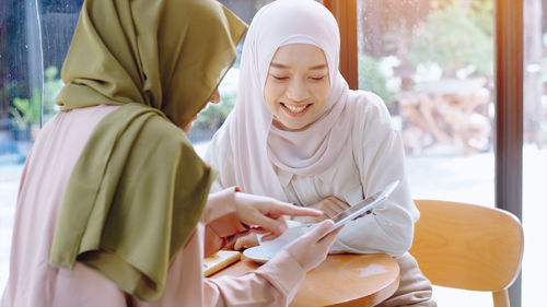 Young woman sitting with text