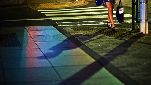 Woman walking along city pavement