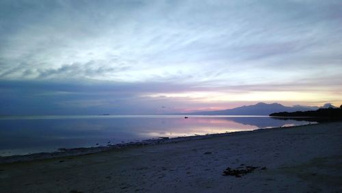 Scenic view of beach against sky during sunset