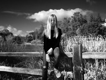 Man standing on mountain against cloudy sky