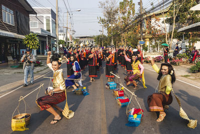 People sitting on street in city