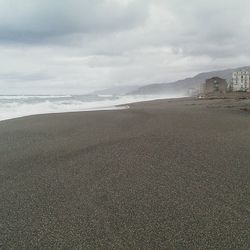 Scenic view of sea against cloudy sky