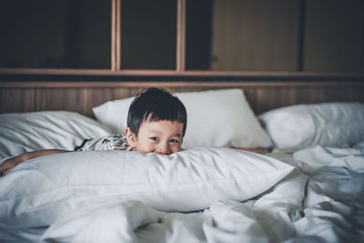 Boy lying on bed at home