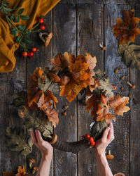 Rear view of woman holding autumn leaves