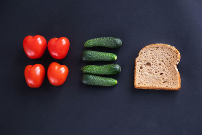 High angle view of tomatoes on table against black background