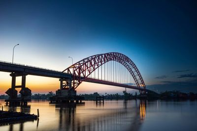 Illuminated bridge over river