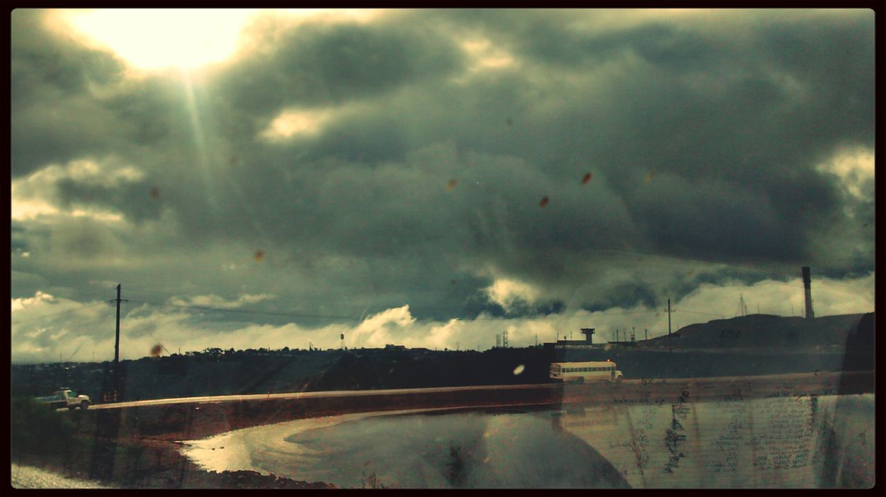 transfer print, sky, cloud - sky, auto post production filter, cloudy, water, cloud, nature, scenics, weather, transportation, beauty in nature, tranquil scene, sunbeam, tranquility, river, overcast, road, sunlight, outdoors