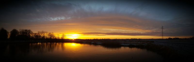 Scenic view of lake against sky during sunset