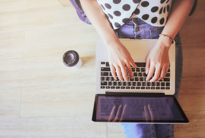 High angle view of girl using laptop on table