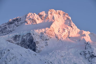 Scenic view of snowcapped mountains against clear sky