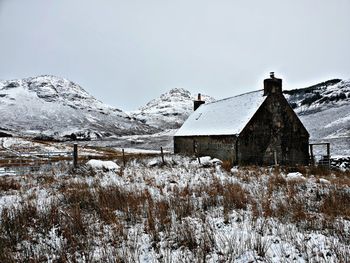 Snow covered buildings against sky