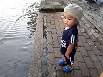 High angle view of cute boy on footpath