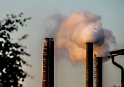 Low angle view of smoke stack against sky