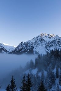 Scenic view of snowcapped mountains against clear sky