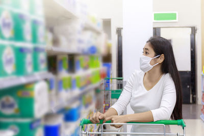 Young woman looking at camera while sitting in store