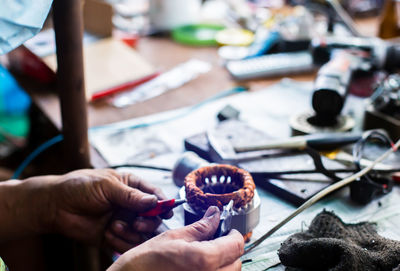 Close-up of people working on table