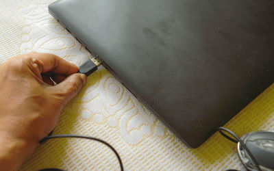 High angle view of person hand on table