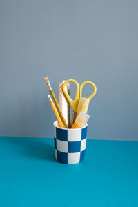 High angle view of chopsticks on table against blue background