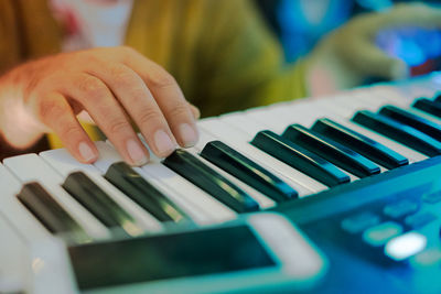 Cropped hand playing piano