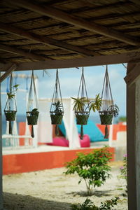 Close-up of clothes hanging at beach against sky