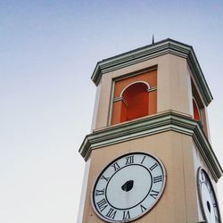 Low angle view of clock tower against clear sky