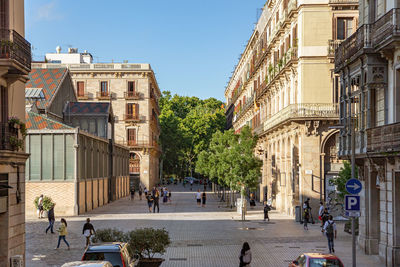 View to carrer de la ribera with people walking during the sunset, in born district of in barcelona.